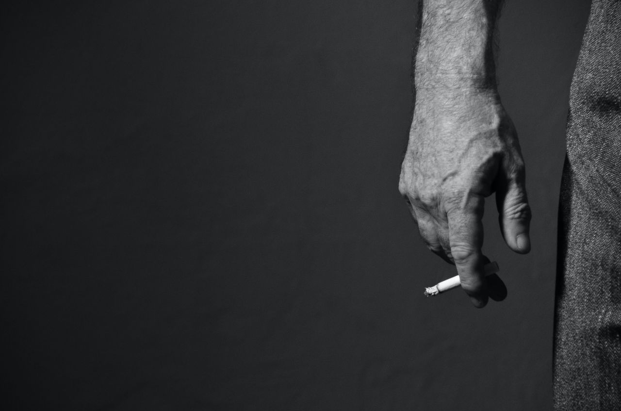 Man smoking CBD to help you quit smoking